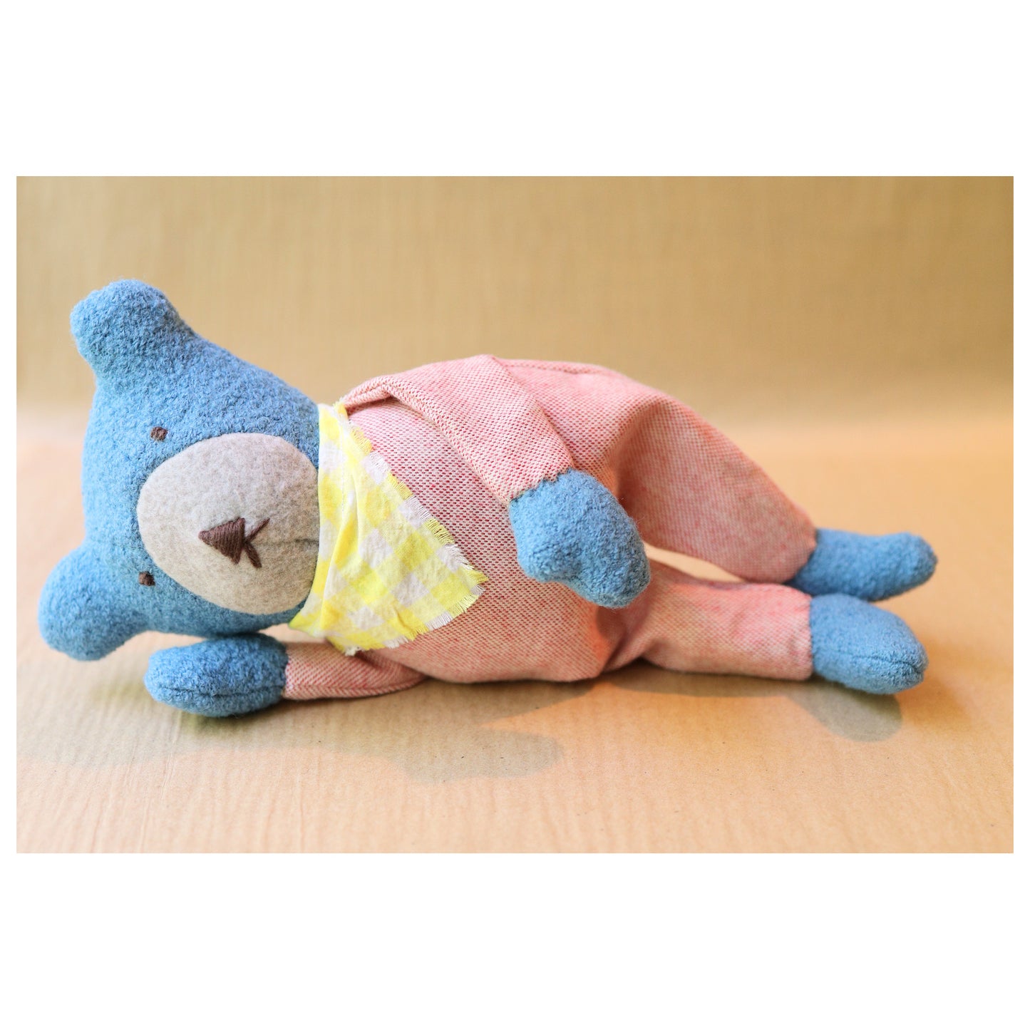 Berry the Floppy Teddy in peach pajamas and wool boucle