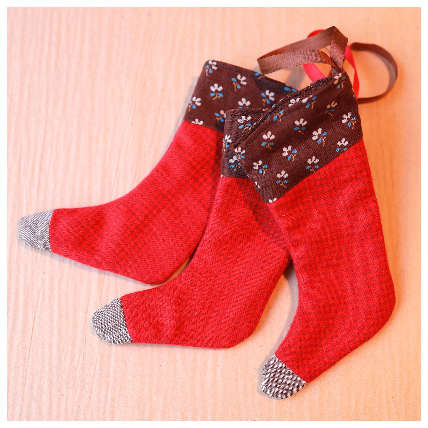 Red stockings with brown floral top on a lbrown background