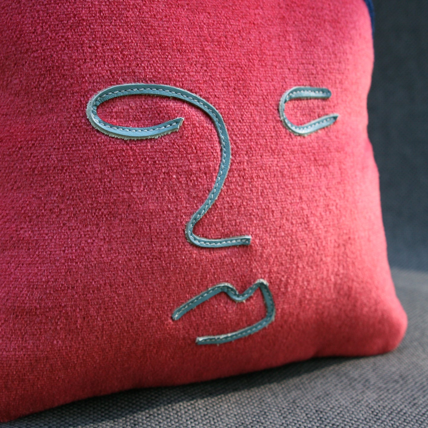 face pillow blue leather close up