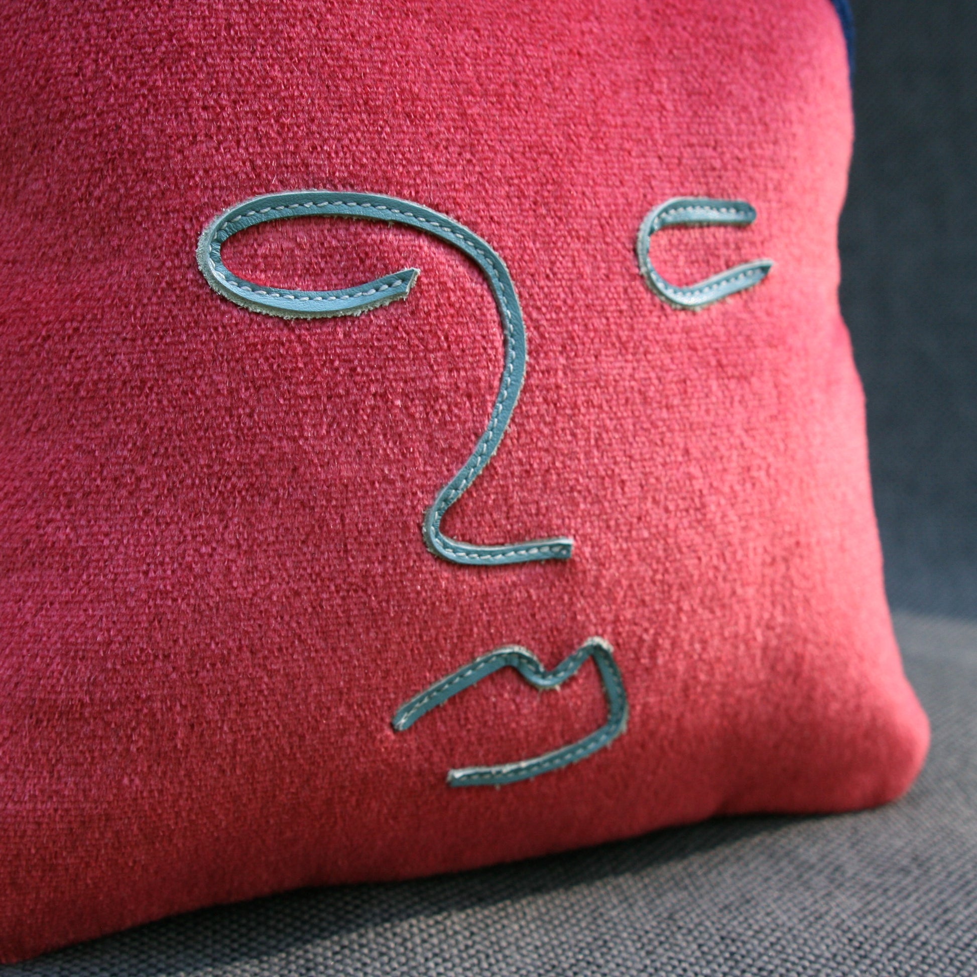 face pillow blue leather close up