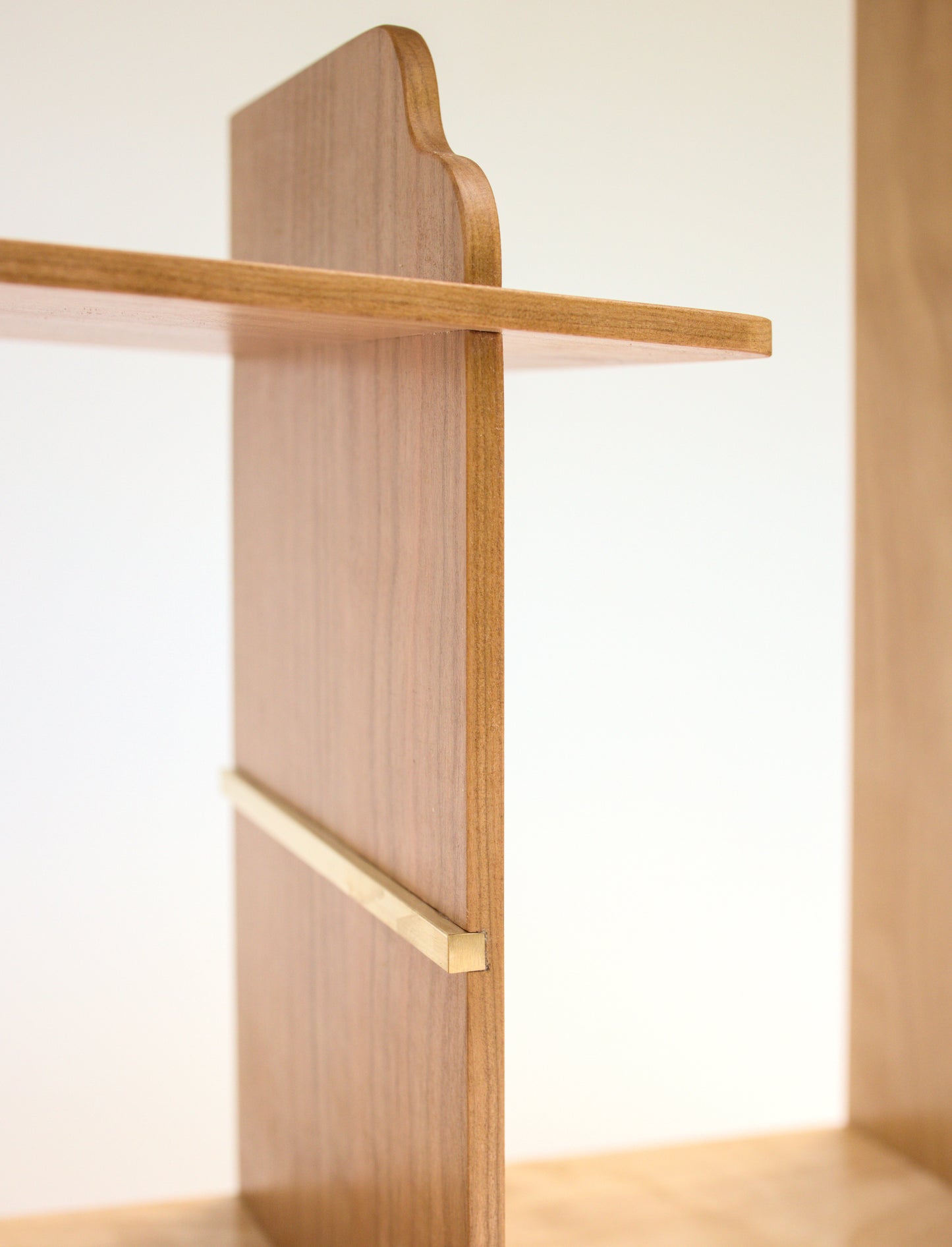 detail of brass in cubby for tea cabinet in cherry