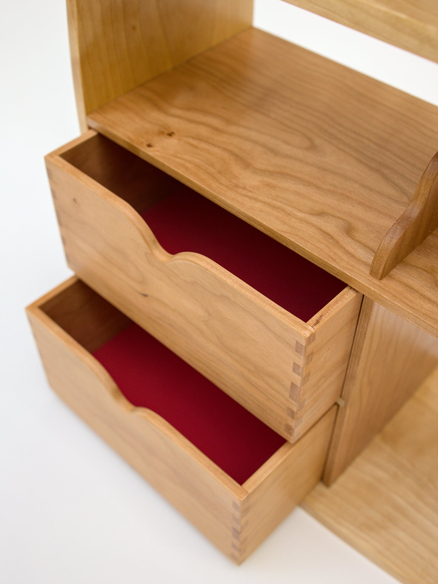 close up of fabric lined drawers for tea cabinet in cherry