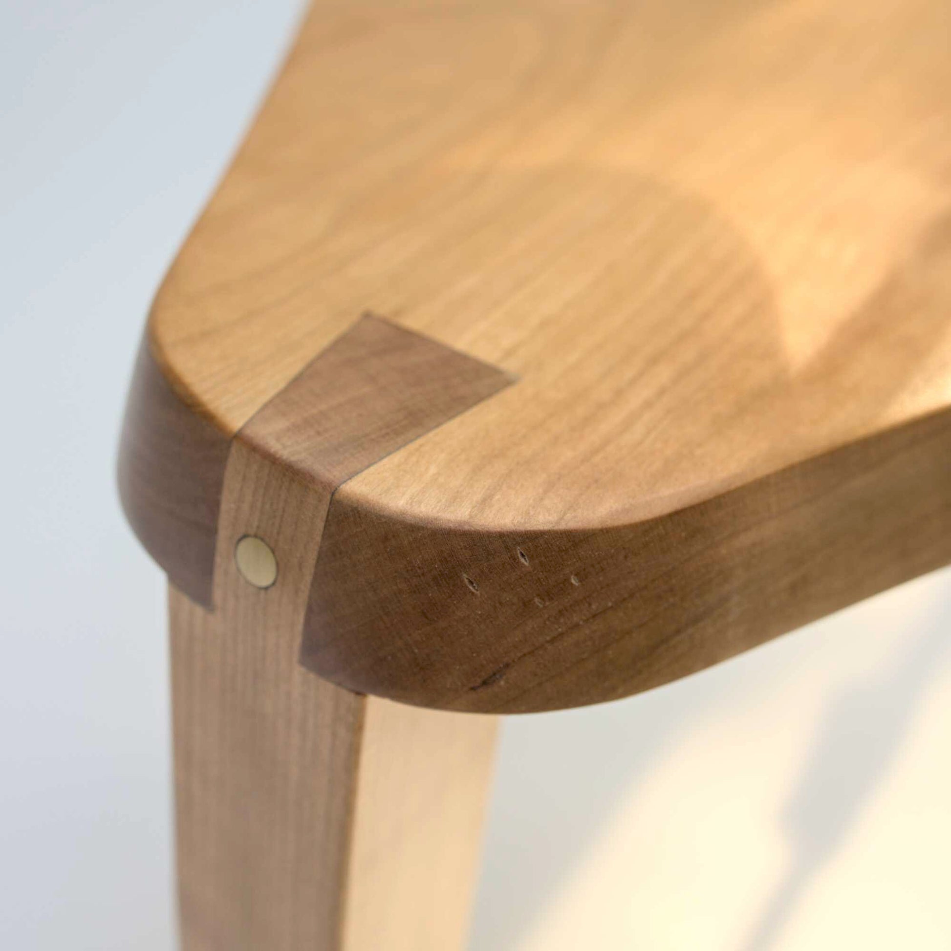 made cozy milking stool dovetailed triangular side table close up of dovetail and brass dowel