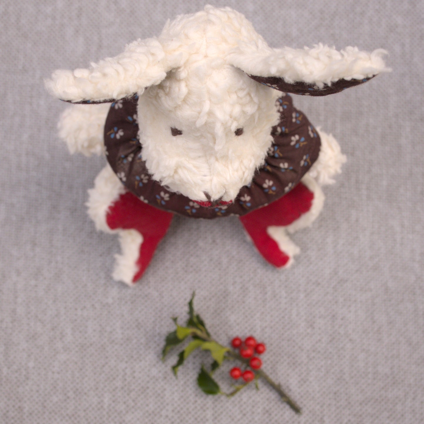 Aster cottontail stuffed wool rabbit in red , white, and brown top view