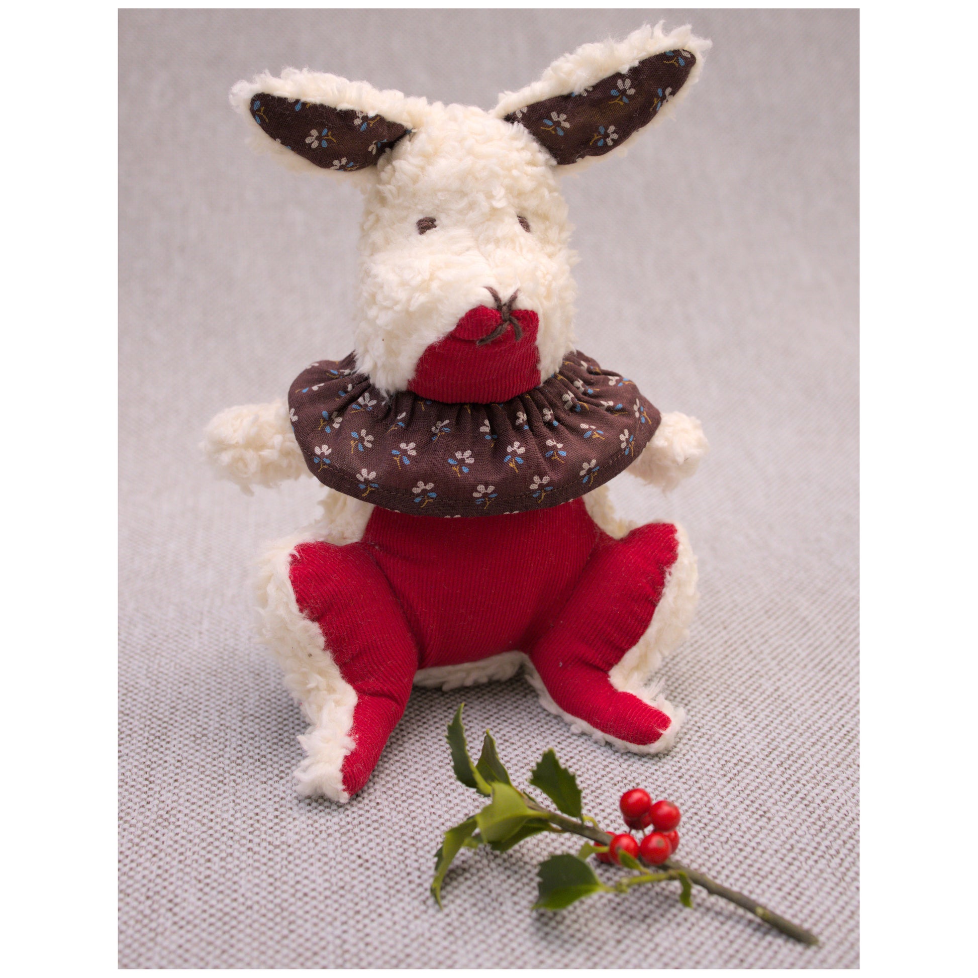 Aster cottontail stuffed wool rabbit in red , white, and brown with winterberry holly