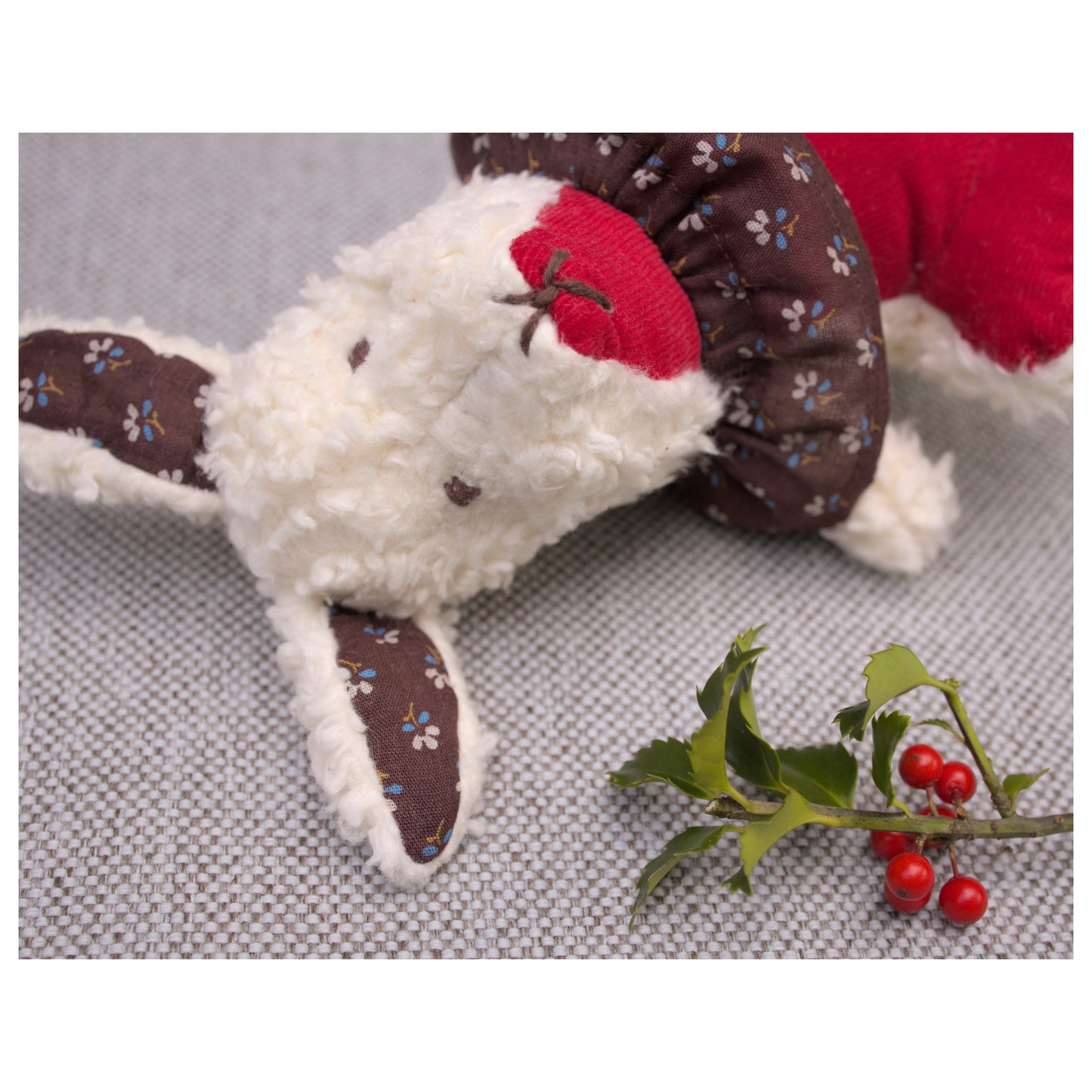 Aster cottontail stuffed wool rabbit in red , white, and brown with winterberry holly for christmas