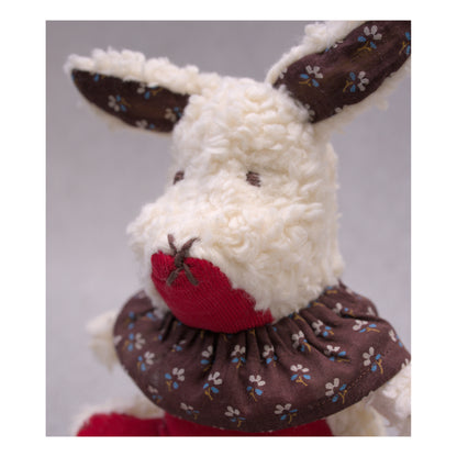 Aster cottontail stuffed wool rabbit in red , white, and brown close up portrait