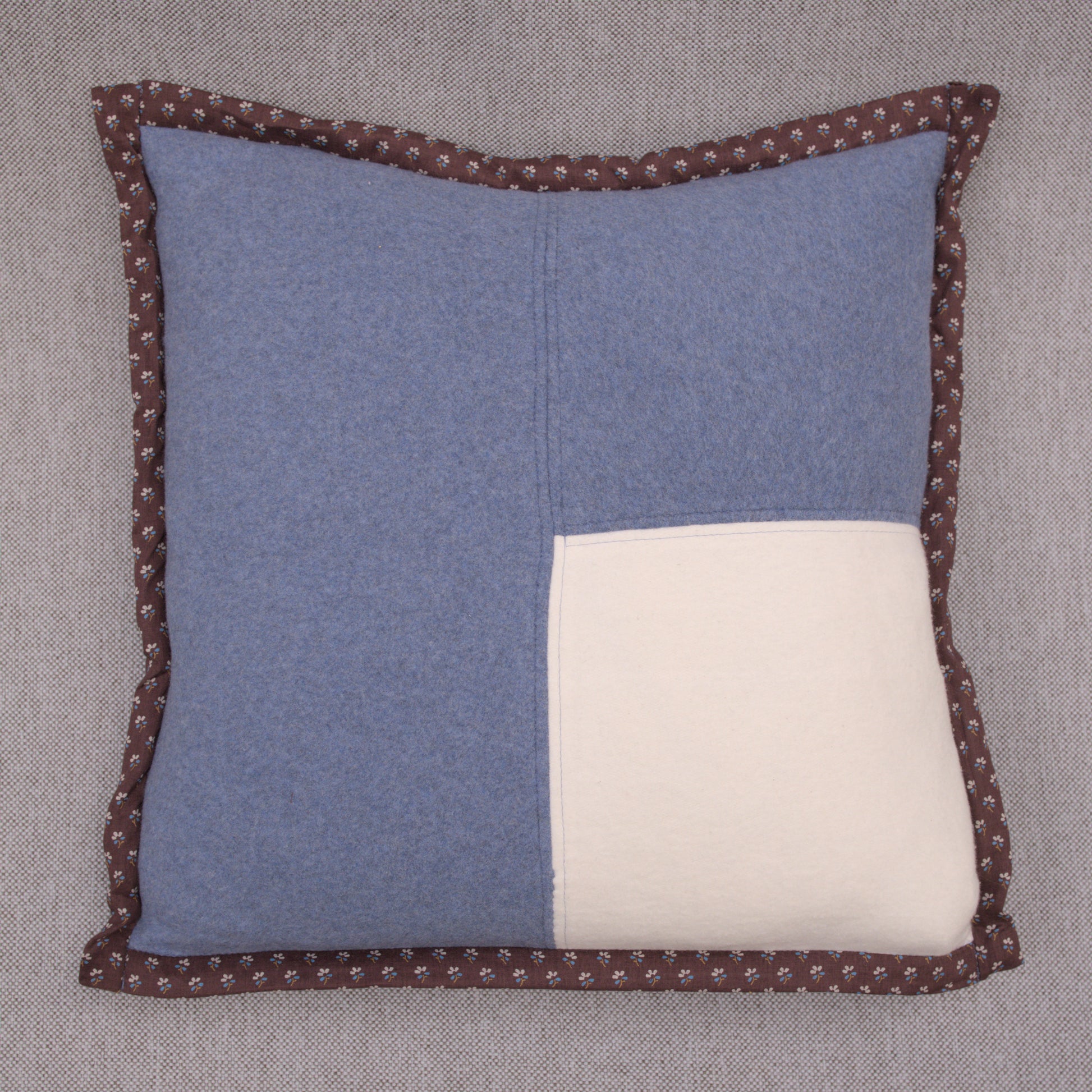 blue cotton fleece pillow with white fleece patch and brown japanese cotton border 