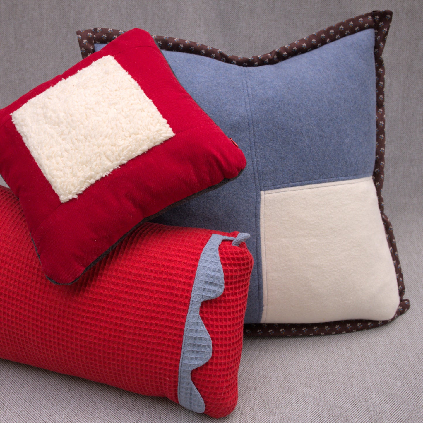 blue cotton fleece pillow with white fleece patch and brown japanese cotton border with red pillows