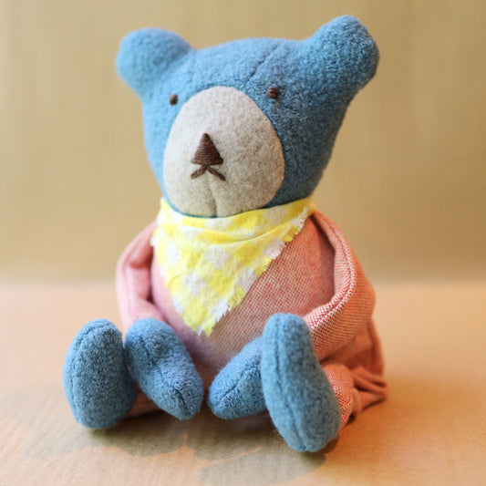 Berry the Floppy Teddy in peach pajamas and wool boucle