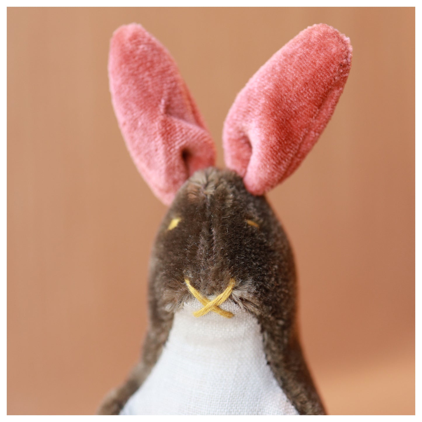 mohair bunny portrait with brown mohair, pink ears, and a light blue linen belly