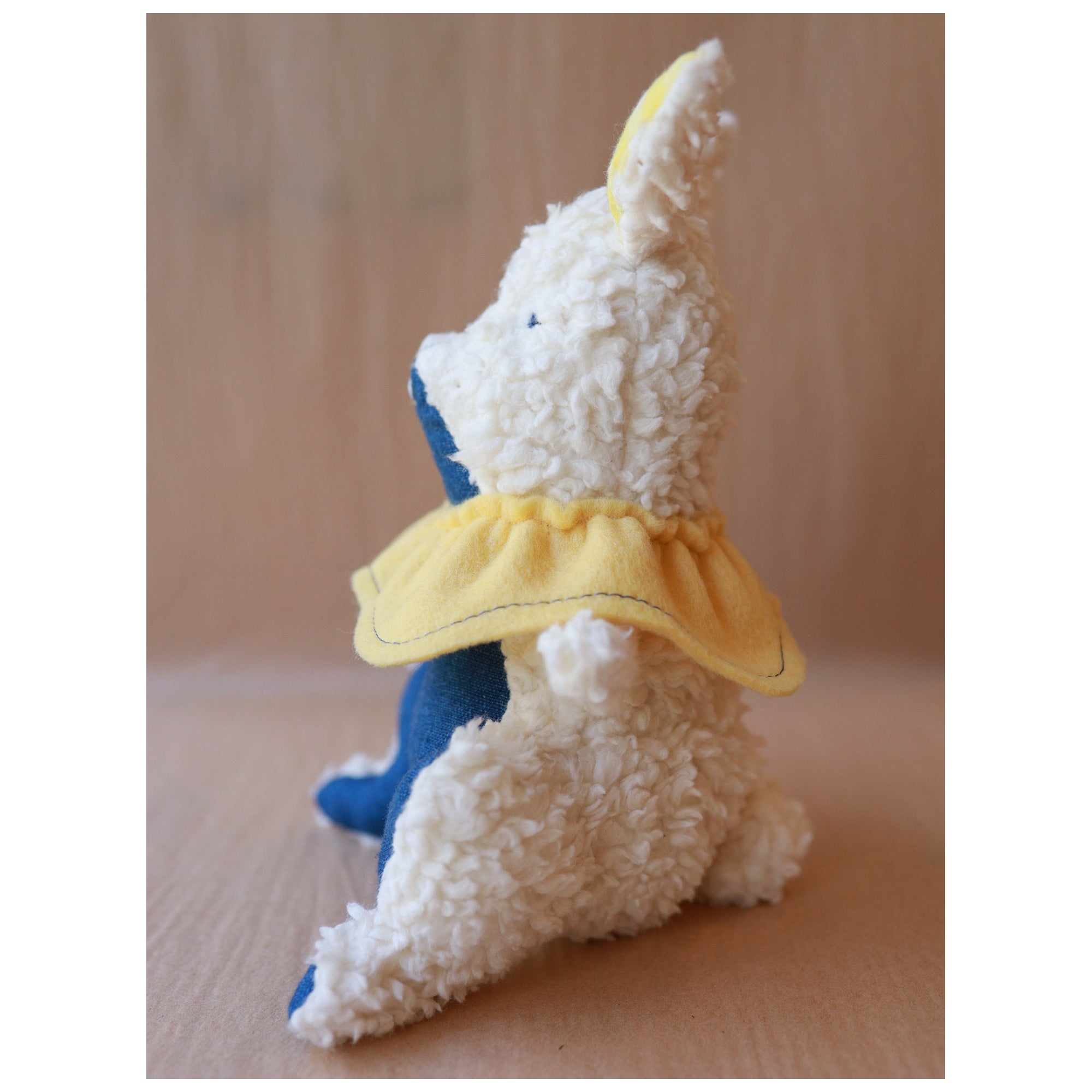 stuffed cotton bunny toy with yellow collar 