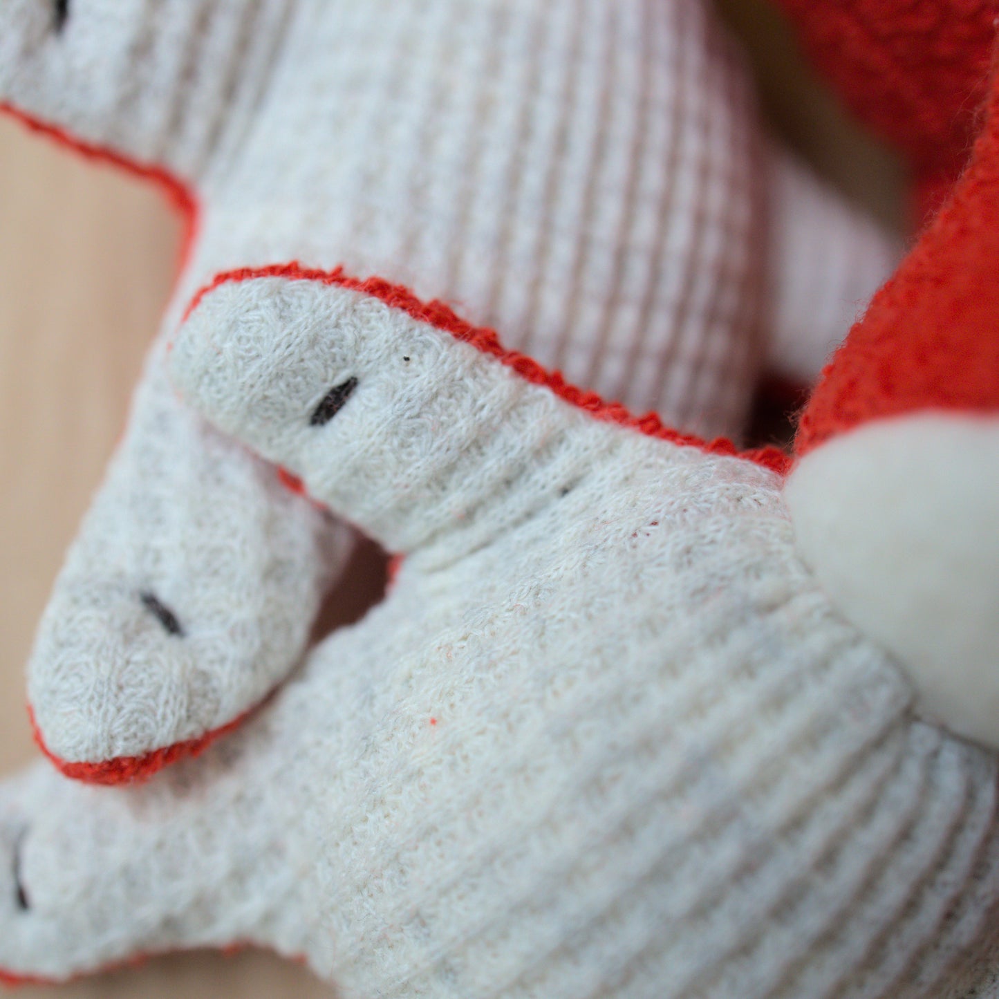 Close up of mini fox toy made from red terrycloth, fleece and light gray waffle fabric