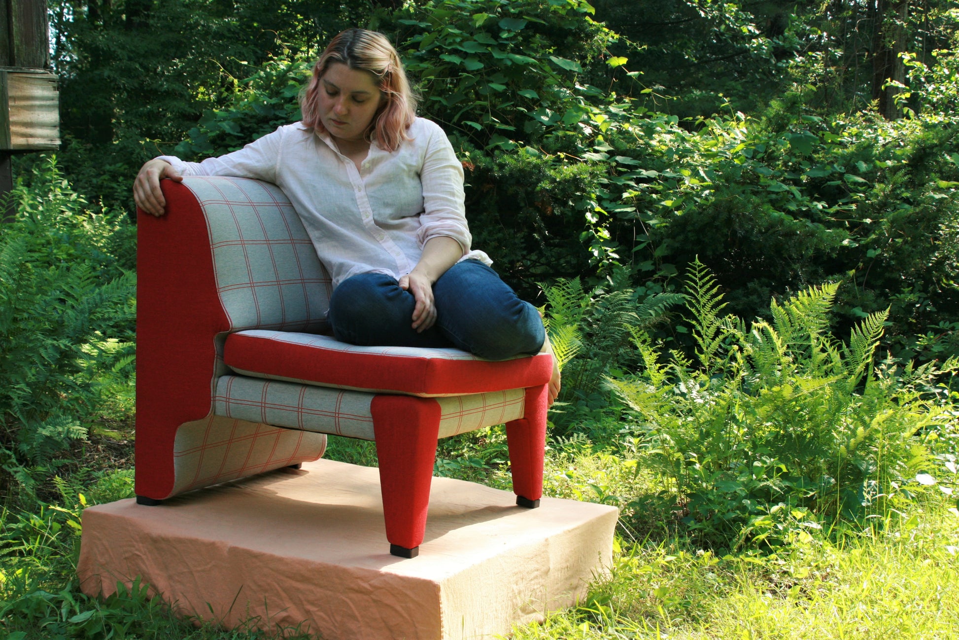 lineament chair, with haviland justice sitting on it, red and grey