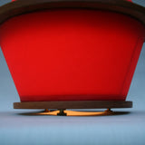 fiery disks lamp waxed sailcloth, red, cherry wood, brass hardware, cloth cord, circle lamp, bottom view